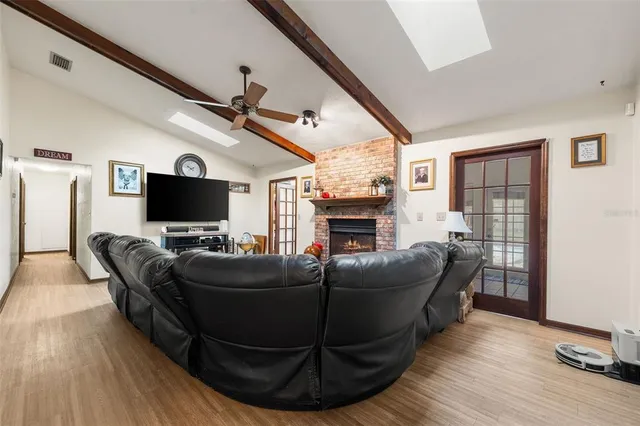 a living room with fireplace furniture and a flat screen tv