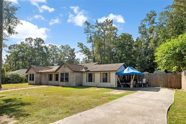 a front view of a house with swimming pool having outdoor seating