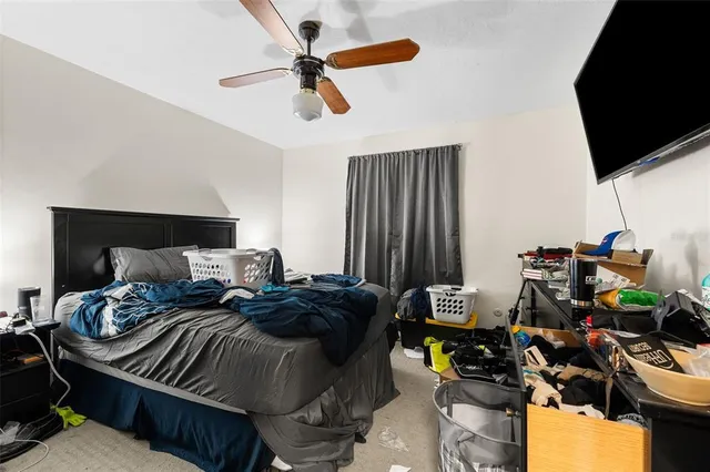 a bedroom with bed and a flat screen tv