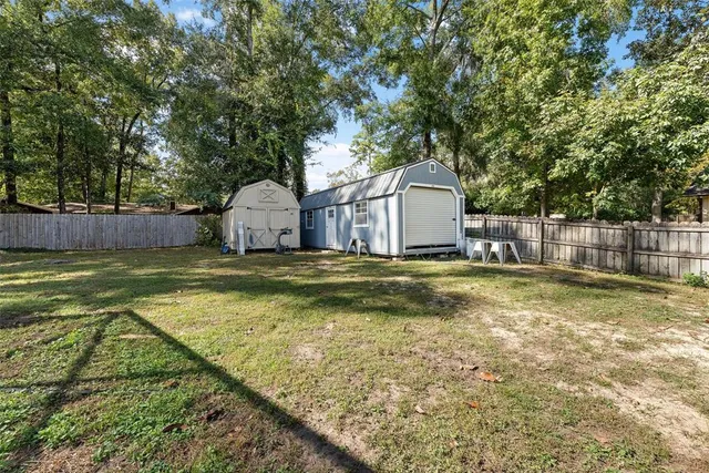 a view of a house with swimming pool and a yard