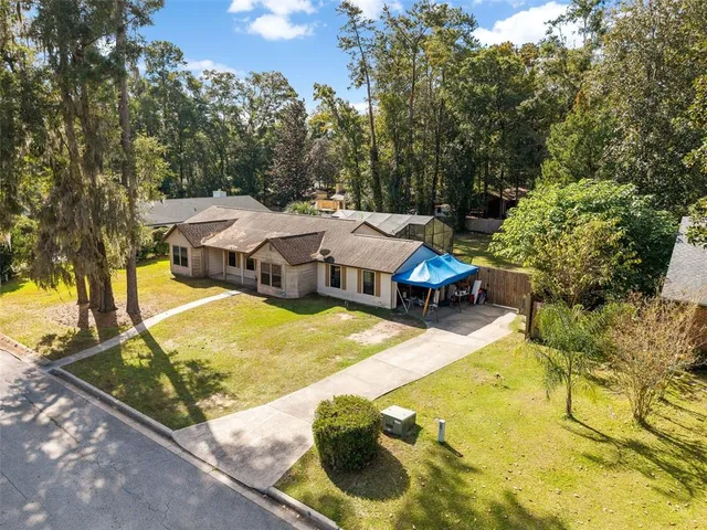 an aerial view of a swimming pool with lawn chairs and plants