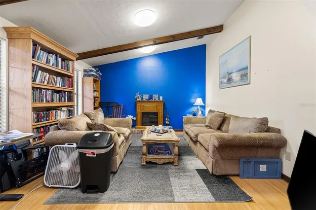 a living room with furniture and a bookshelf