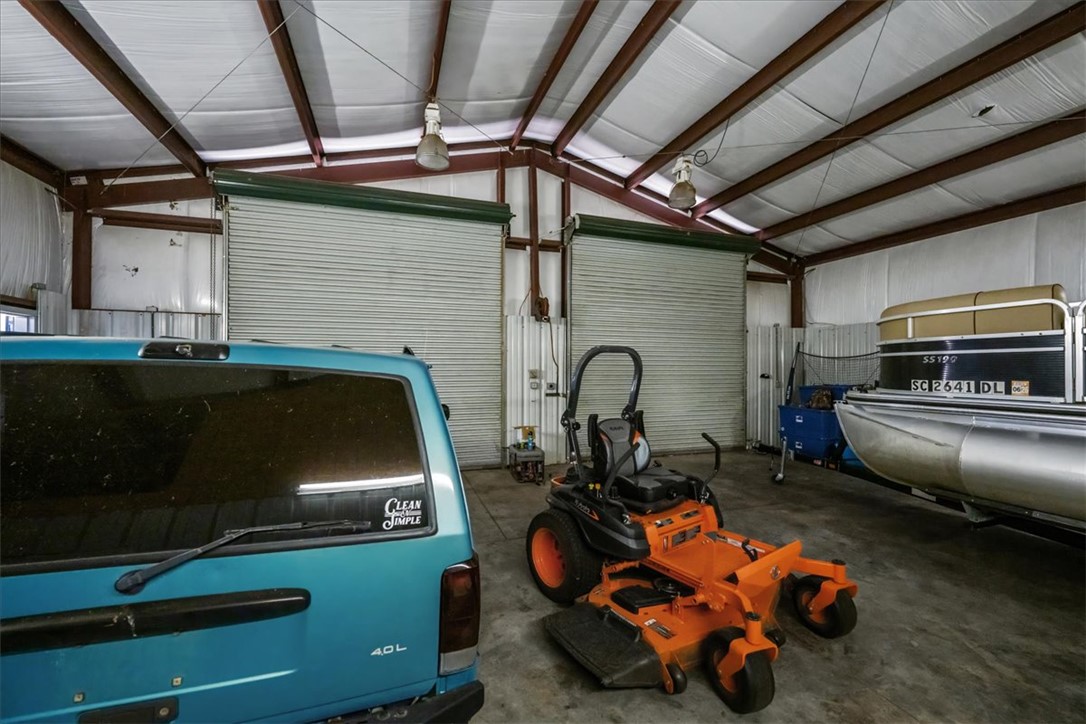 212 Winding Lane Seneca, SC 29672 - Photo 45 of 47 This spacious garage offers ample room for vehicles and equipment, featuring convenient roll-up doors.