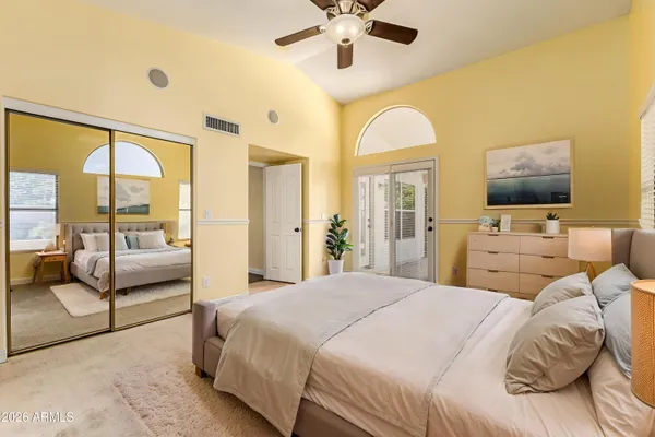a bedroom with a large bed and a chandelier