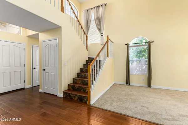 a view of entryway and hall with wooden floor