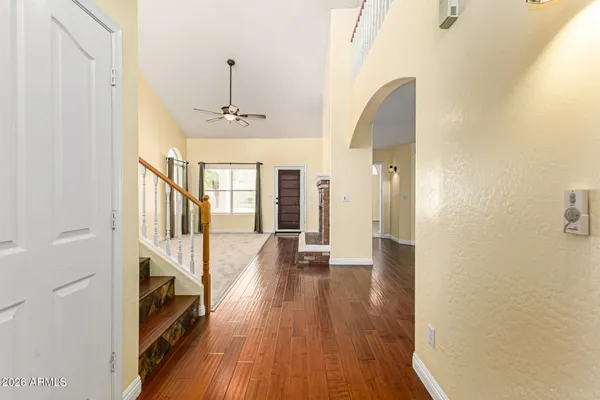a view of a hallway with wooden floor and staircase