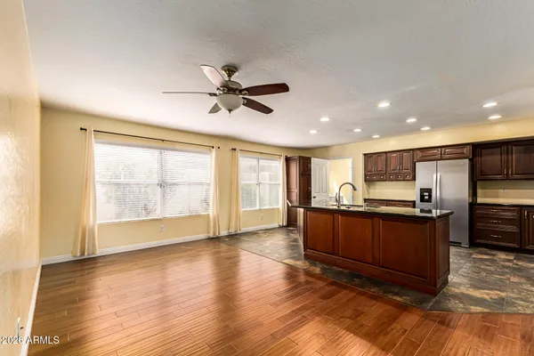 a view of a kitchen with a sink and a refrigerator