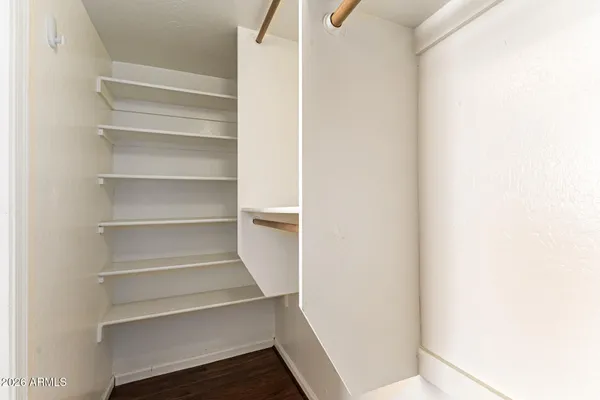 an empty room with wooden floor and window