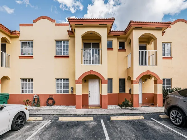 a front view of a house with parking space