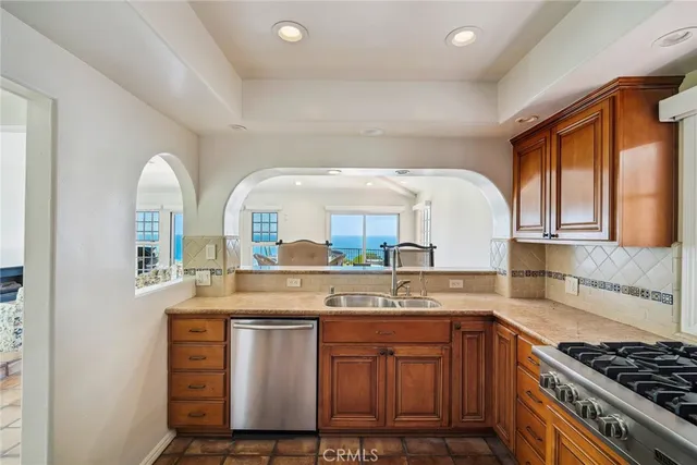 a kitchen with stainless steel appliances granite countertop a stove and a sink
