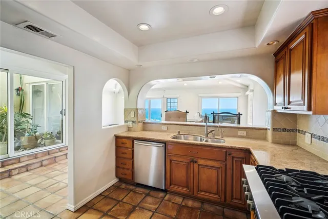 a kitchen with stainless steel appliances granite countertop a stove and a sink