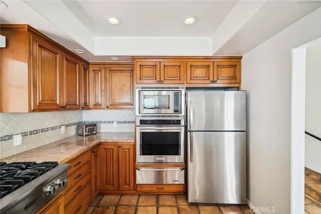 a kitchen with stainless steel appliances a refrigerator and a sink