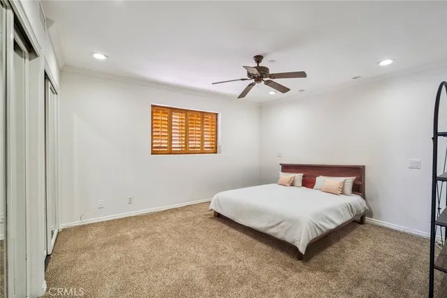 a living room with furniture a ceiling fan and a rug
