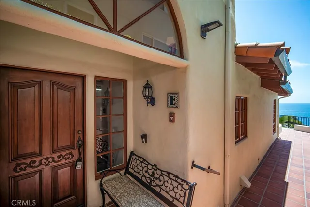 a patio with a table and chairs under an umbrella
