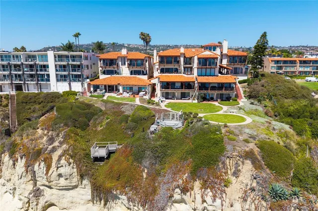an aerial view of residential houses with outdoor space and swimming pool