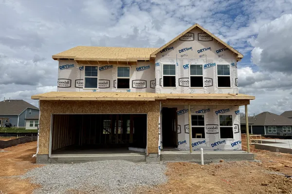 a front view of a house with a yard