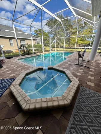 a view of a swimming pool with a patio