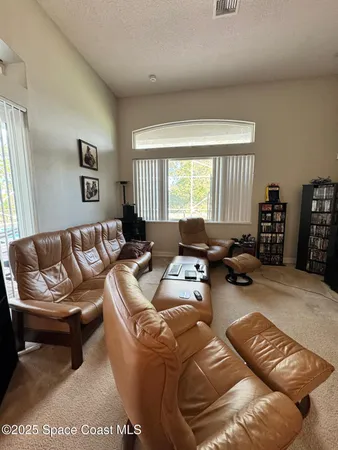 a living room with furniture ceiling window and a couch
