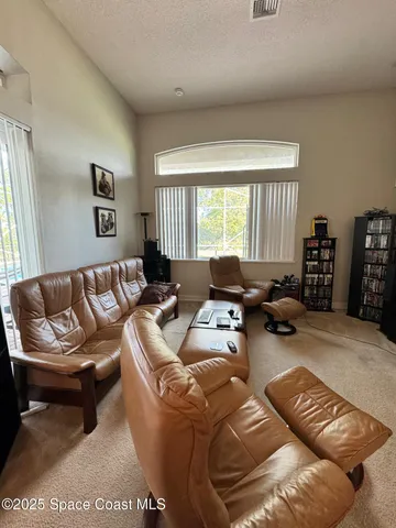 a living room with furniture ceiling window and a couch
