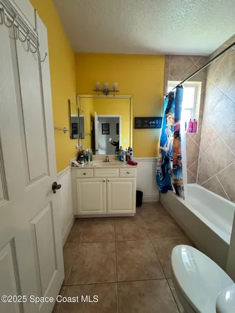 a bathroom with a sink a mirror and a shower