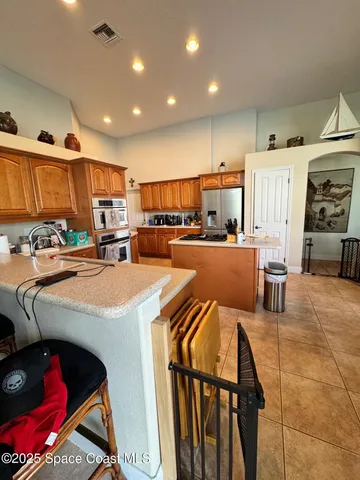 a kitchen with stainless steel appliances a stove a sink and a refrigerator