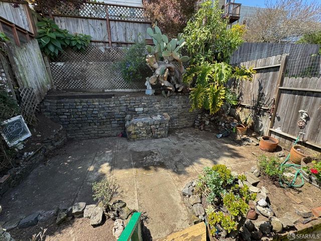 a view of a house with yard and sitting area