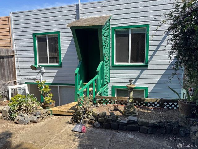 a view of a house with yard and sitting area