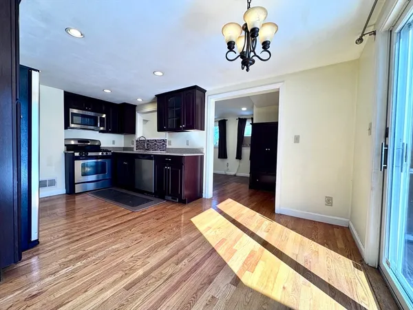 a view of kitchen with sink microwave and refrigerator