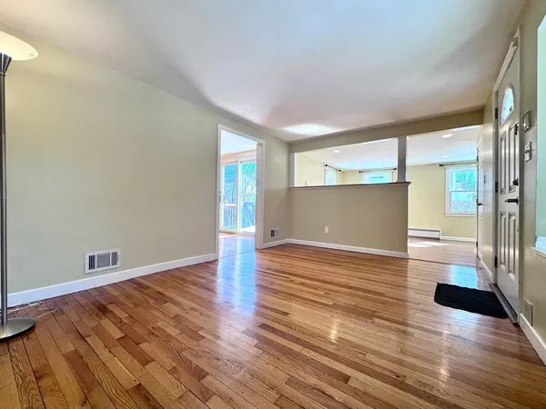a view of empty room with wooden floor