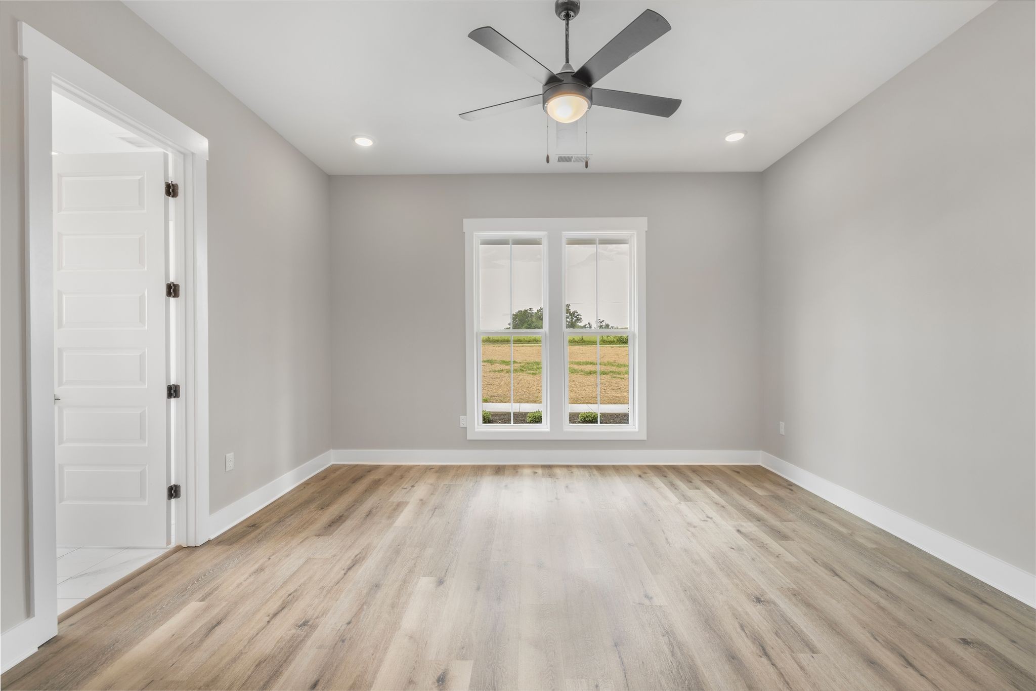 1694 McAfee Road Morrison, TN 37357 - Photo 17 of 41 a view of an empty room with wooden floor and a window
