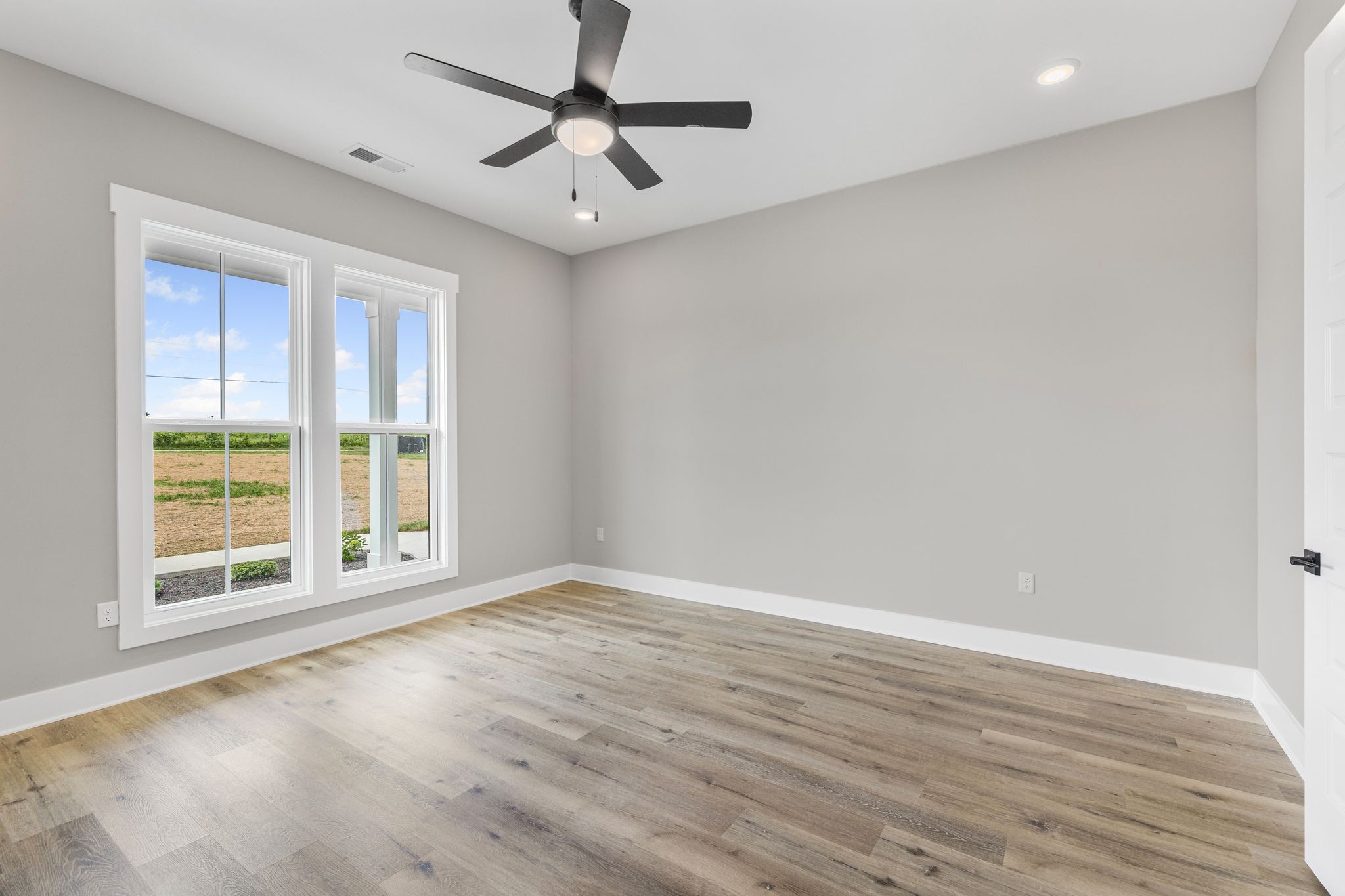 1694 McAfee Road Morrison, TN 37357 - Photo 18 of 41 a view of an empty room with wooden floor and a window