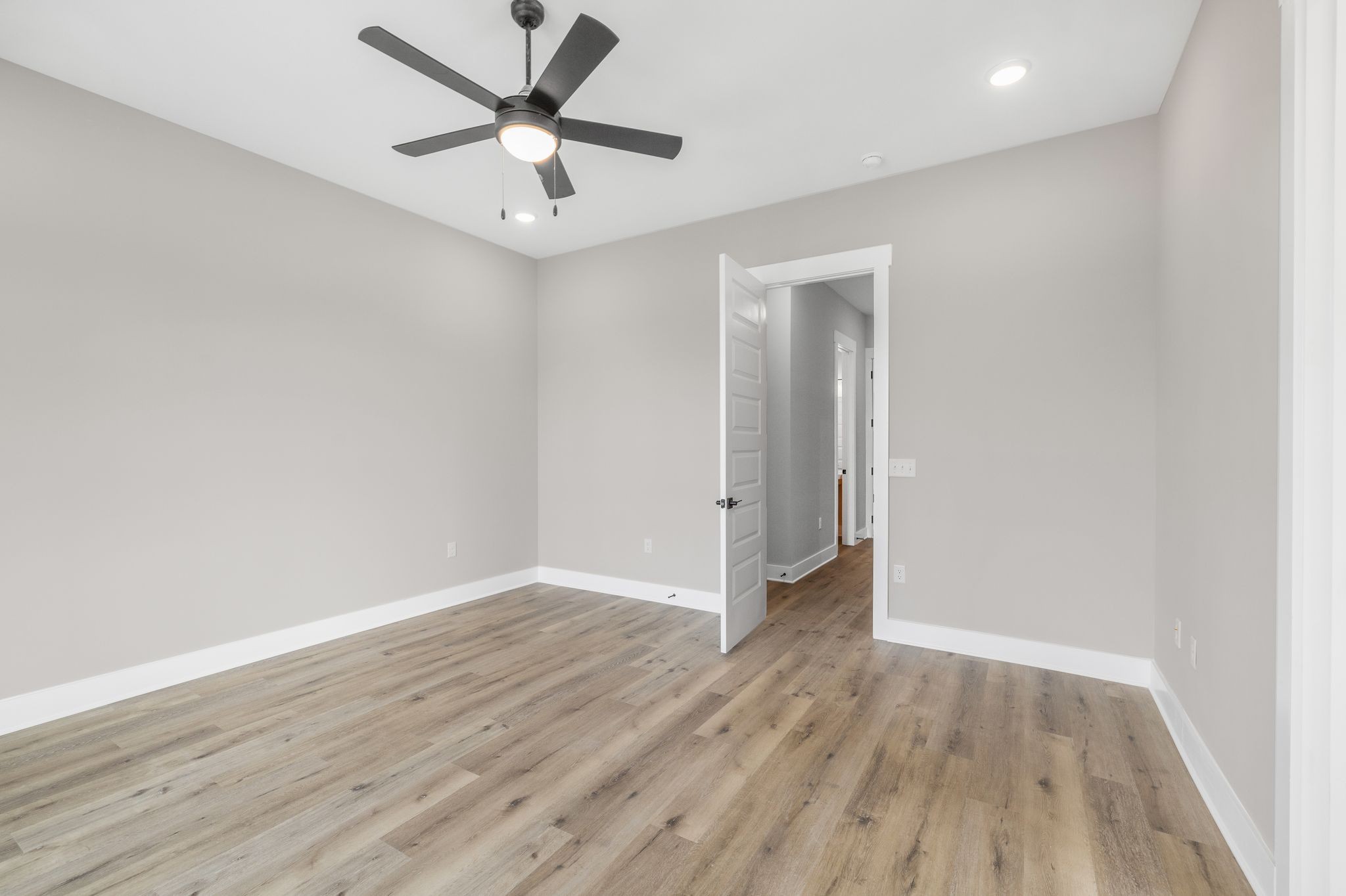 1694 McAfee Road Morrison, TN 37357 - Photo 19 of 41 an empty room with wooden floor and a ceiling fan