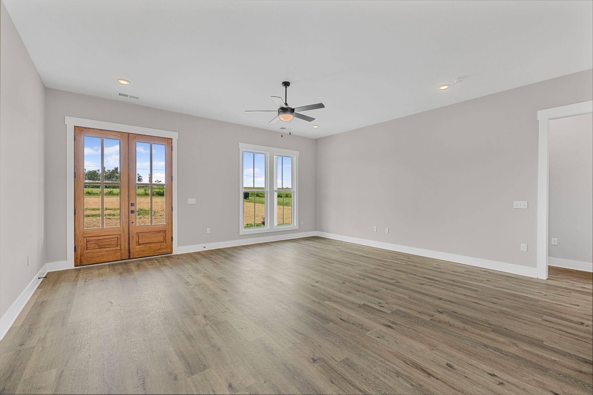 1694 McAfee Road Morrison, TN 37357 - Photo 8 of 41 a view of an empty room with a window and wooden floor