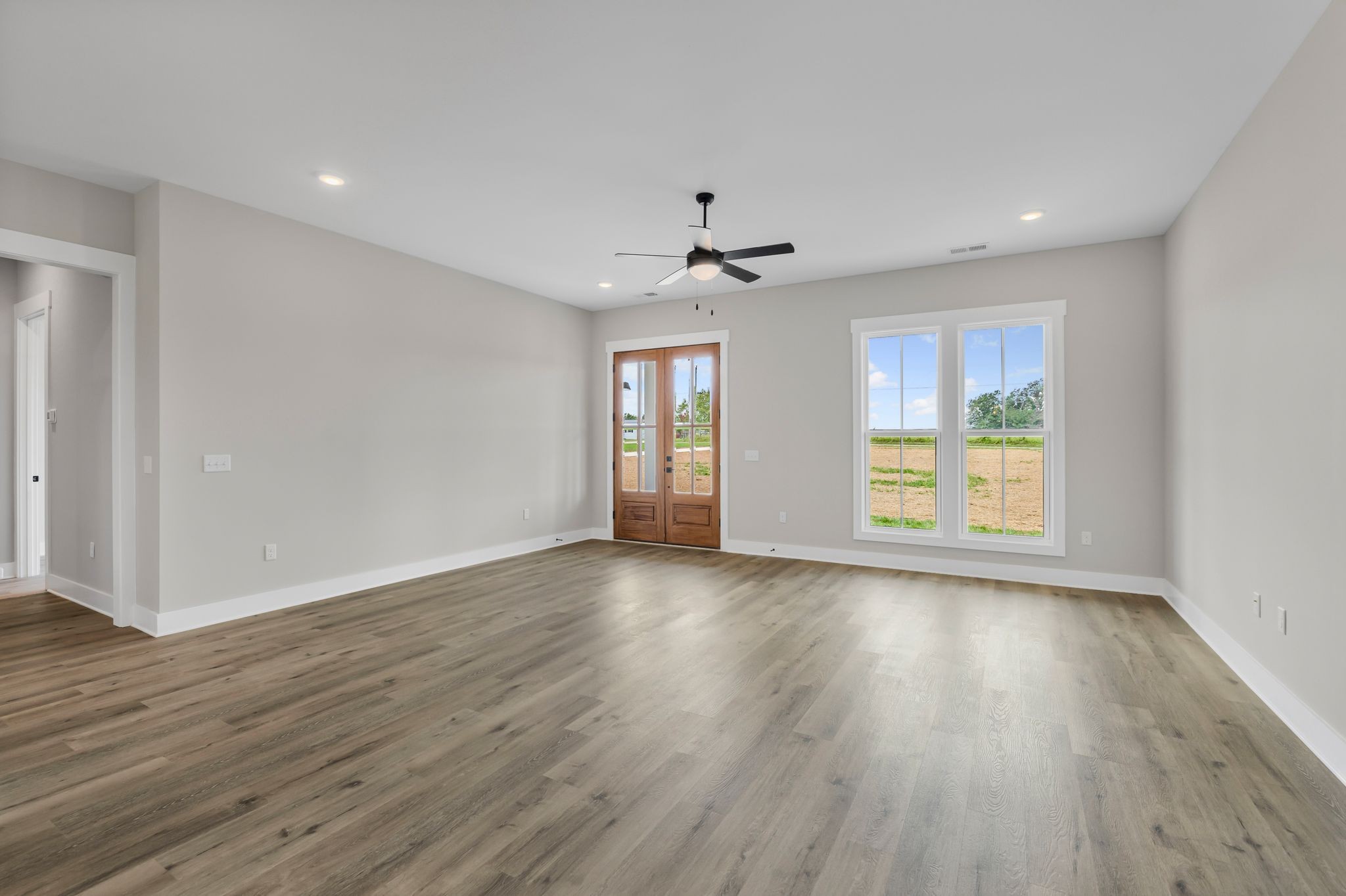 1694 McAfee Road Morrison, TN 37357 - Photo 9 of 41 a view of an empty room with a window and wooden floor
