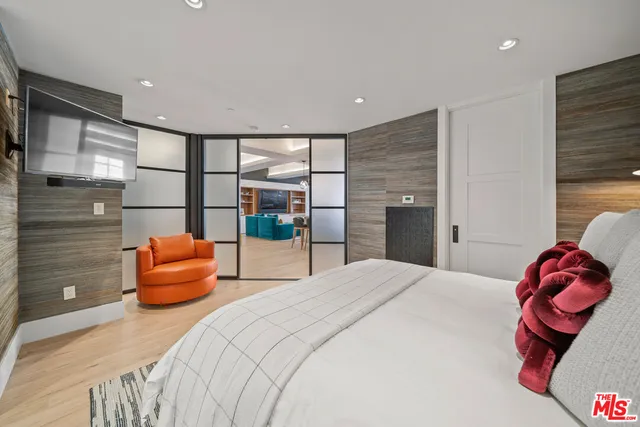 a bedroom with a bed and a couch