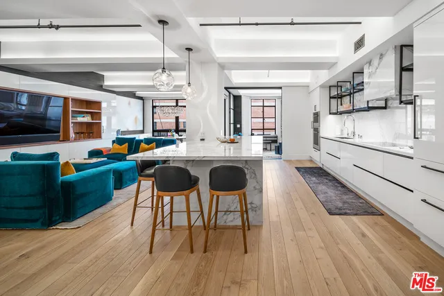 a kitchen with stainless steel appliances granite countertop a stove and a wooden floors