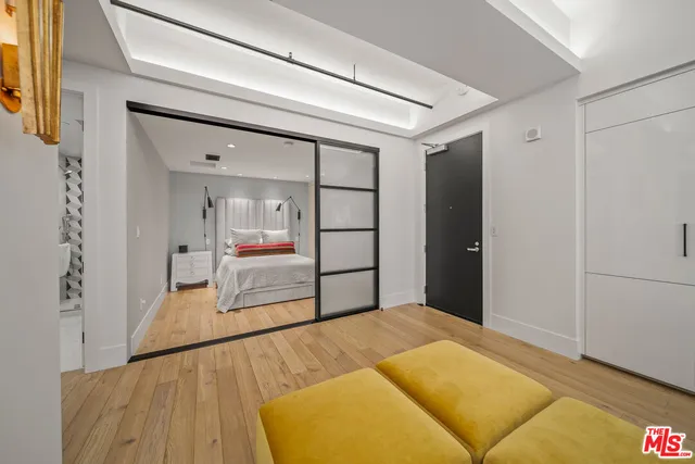 a bedroom with a bed and a painting on the wall