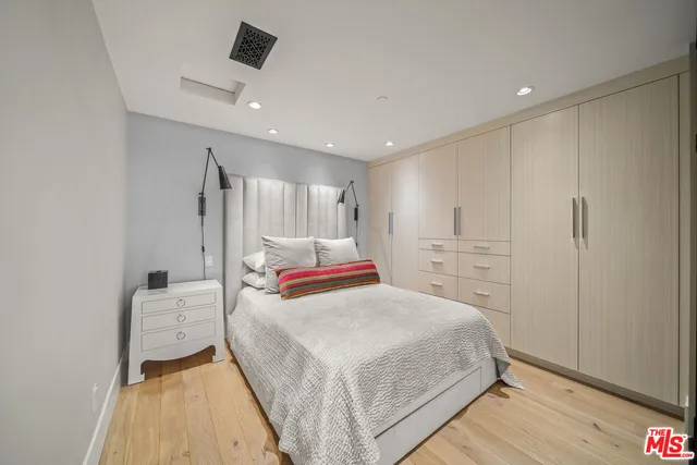 a bedroom with a bed and a mirror