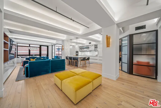 a large kitchen with stainless steel appliances wooden floors and wooden cabinets