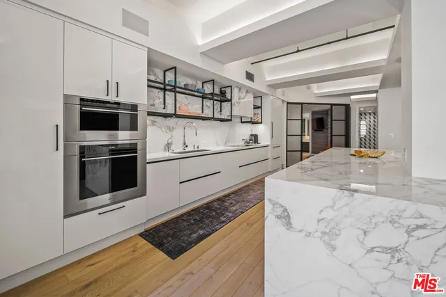 a kitchen with stainless steel appliances granite countertop a stove and a sink