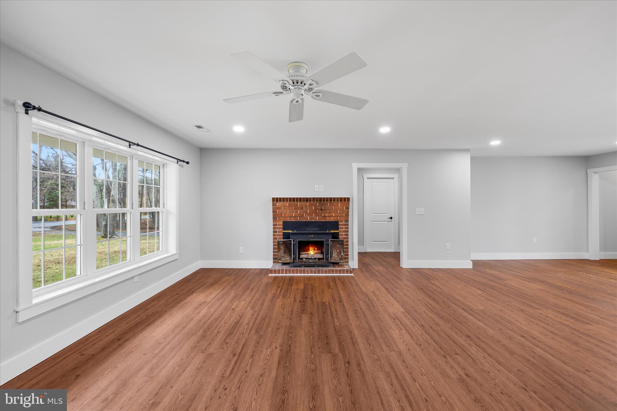 24163 Old Meadow Road Seaford, DE 19973 - Photo 7 of 98 Expansive living room with fireplace and windows