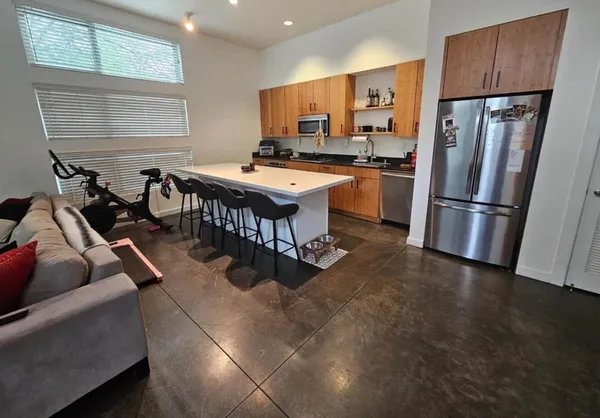 a kitchen with stainless steel appliances a stove a refrigerator and a refrigerator