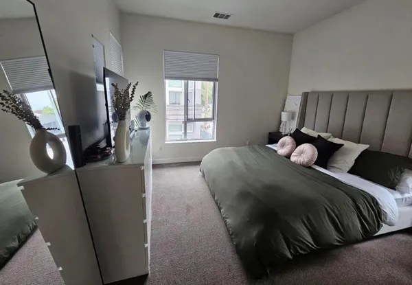 a bedroom with a bed and wooden floor