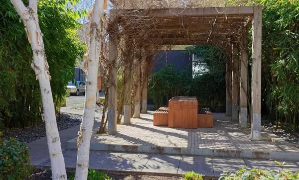 a view of a patio with table and chairs and potted plants