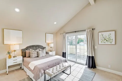 a bedroom with a bed and a painting on the wall