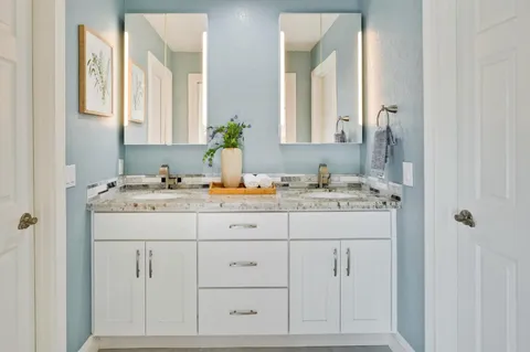 a bathroom with a toilet a sink and mirror