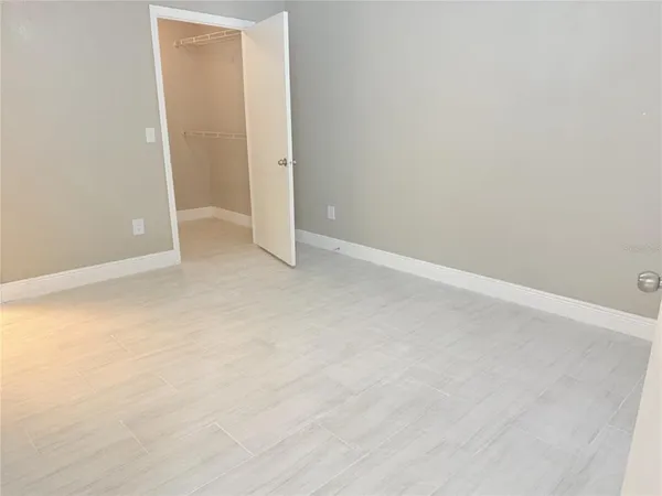 a view of an empty room with a closet