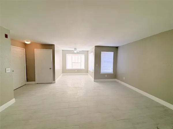 a view of a kitchen with a sink and a refrigerator