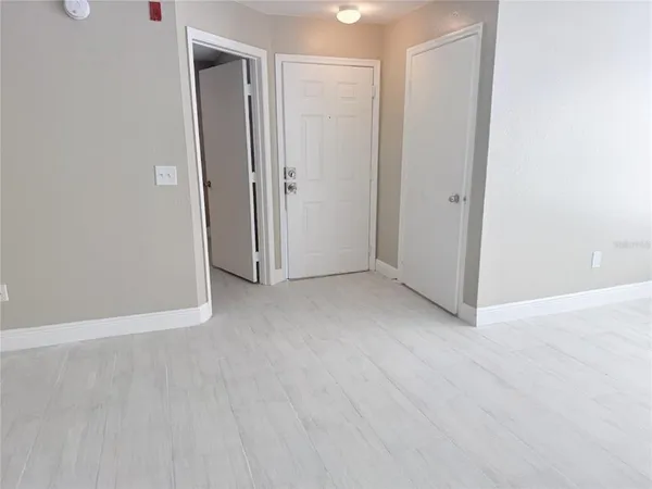 a view of an empty room with closet