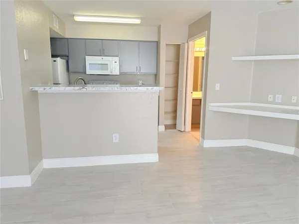 a kitchen with a sink stove and refrigerator